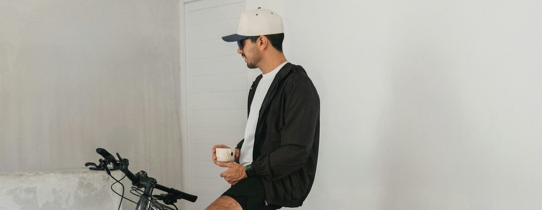 a man sitting on a bike with a dog