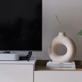 a tv on a stand with decor
